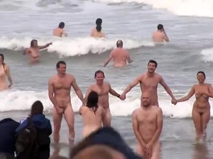 Hundreds Of Nudist People Running Into The Sea Naked